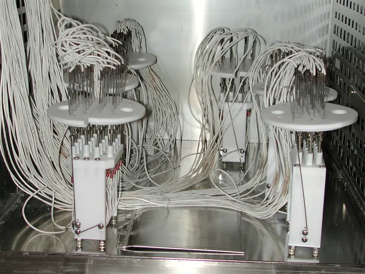 Wire specimen jigs loaded in an environmental test chamber